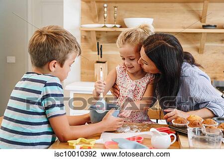 Mother and children baking cupcakes in kitchen View Large Photo Image Stock Image - Mother and children baking cupcakes in kitchen. Fotosearch