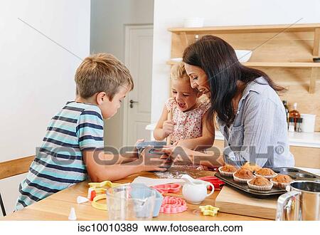 Mother and children baking cupcakes in kitchen View Large Photo Image Stock Photo - Mother and children baking cupcakes in kitchen. Fotosearch