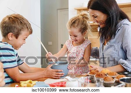 Mother and children baking cupcakes in kitchen View Large Photo Image Stock Photo - Mother and children baking cupcakes in kitchen. Fotosearch