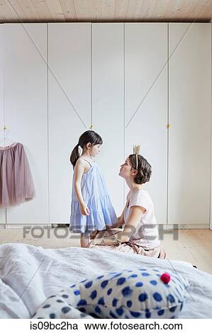 Mother and daughter in bedroom, face to face, mother wearing crown headband View Large Photo Image Stock Image - Mother and daughter in bedroom, face to face, mother wearing crown headband. Fotosearch