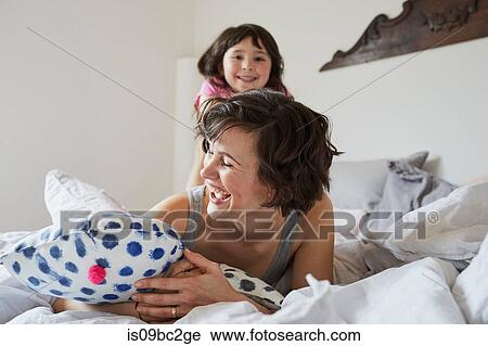 Mother and daughter playing in bedroom, laughing View Large Photo Image Stock Image - Mother and daughter playing in bedroom, laughing. Fotosearch