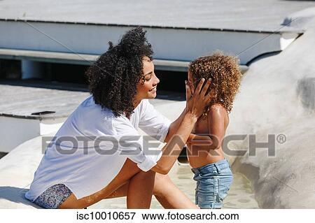 Mother and daughter playing in manmade pool View Large Photo Image Stock Photo - Mother and daughter playing in manmade pool. Fotosearch