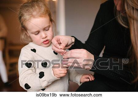 Stock Image - Mother and daughter preparing for Christmas. Fotosearch
