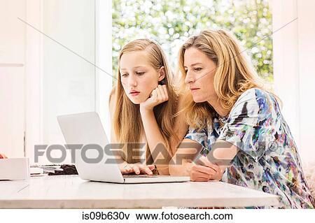 Stock Photo - Mother and daughter using laptop. Fotosearch