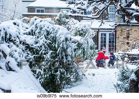 Mother and son in garden playing in snow View Large Photo Image Stock Photography - Mother and son in garden playing in snow. Fotosearch