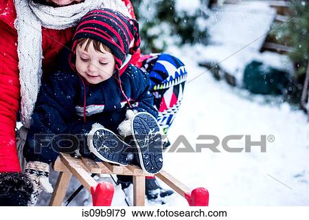 Mother and son in snow on toboggan View Large Photo Image Stock Photo - Mother and son in snow on toboggan. Fotosearch
