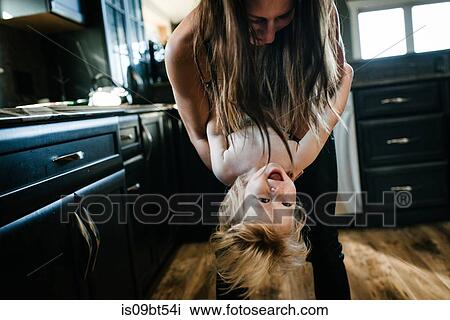 Mother and son playing in kitchen View Large Photo Image Stock Image - Mother and son playing in kitchen. Fotosearch