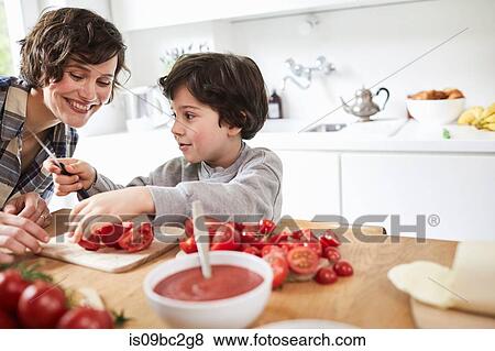 Mother and son preparing food in kitchen View Large Photo Image Stock Photo - Mother and son preparing food in kitchen. Fotosearch