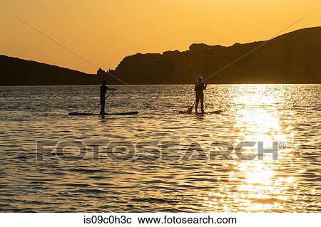 Mother and son standup paddleboarding in sea at sunset, Limnos, Khios, Greece View Large Photo Image Stock Image - Mother and son standup paddleboarding in sea at sunset, Limnos, Khios, Greece. Fotosearch