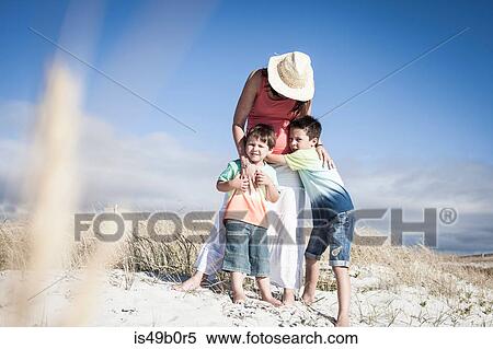 Stock Photography - Mother and sons on beach, Cape Town, South Africa. Fotosearch