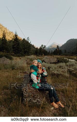Mother and toddler daughter sitting on boulder in rural valley, portrait, Mineral King, California, USA View Large Photo Image Stock Photo - Mother and toddler daughter sitting on boulder in rural valley, portrait, Mineral King, California, USA. Fotosearch