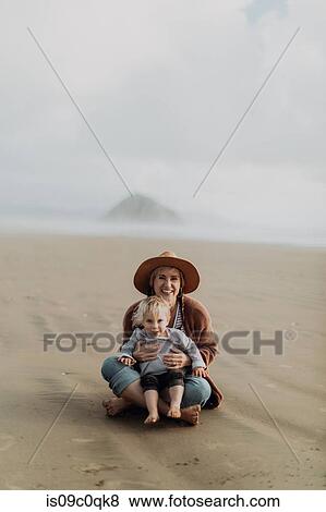 Mother and toddler sitting on beach, Morro Bay, California, United States View Large Photo Image Stock Photo - Mother and toddler sitting on beach, Morro Bay, California, United States. Fotosearch