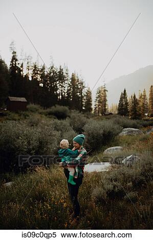 Stock Photography - Mother carrying toddler daughter in rural valley, Mineral King, California, USA. Fotosearch