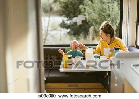 Mother feeding baby breakfast in motorhome View Large Photo Image Stock Image - Mother feeding baby breakfast in motorhome. Fotosearch