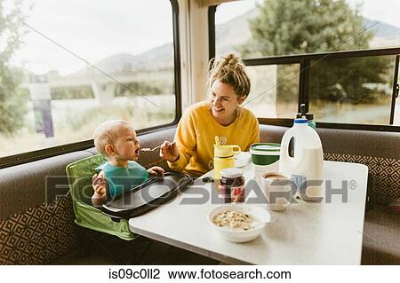 Mother feeding baby breakfast in motorhome View Large Photo Image Stock Image - Mother feeding baby breakfast in motorhome. Fotosearch