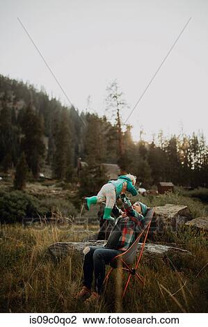 Mother holding up toddler daughter in rural valley, Mineral King, California, USA View Large Photo Image Stock Image - Mother holding up toddler daughter in rural valley, Mineral King, California, USA. Fotosearch