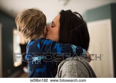 Mother hugging and kissing son View Large Photo Image Stock Image - Mother hugging and kissing son. Fotosearch