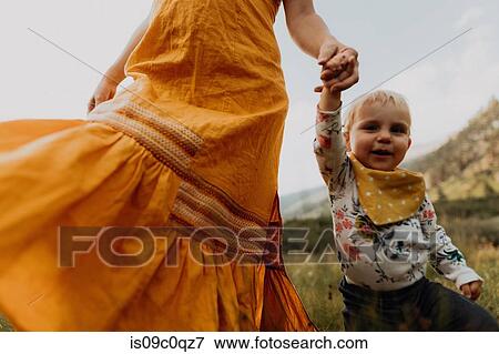 Mother in maxi dress walking with toddler daughter in rural valley, cropped, Mineral King, California, USA View Large Photo Image Stock Photo - Mother in maxi dress walking with toddler daughter in rural valley, cropped, Mineral King, California, USA. Fotosearch