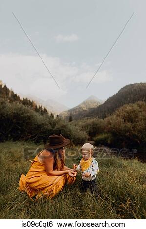 Mother looking at wildflower with toddler daughter in rural valley, Mineral King, California, USA View Large Photo Image Stock Photograph - Mother looking at wildflower with toddler daughter in rural valley, Mineral King, California, USA. Fotosearch