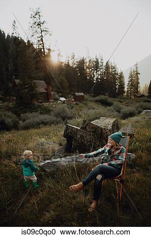 Stock Image - Mother relaxing with toddler daughter in rural valley, Mineral King, California, USA. Fotosearch