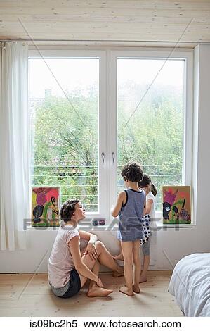 Mother sitting beside window, talking to son and daughter View Large Photo Image Stock Photography - Mother sitting beside window, talking to son and daughter. Fotosearch