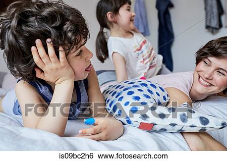 Mother, son and daughter, relaxing in bedroom View Large Photo Image Stock Photograph - Mother, son and daughter, relaxing in bedroom. Fotosearch