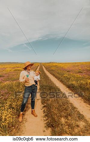 Stock Photograph - Mother with baby girl in countryside. Fotosearch