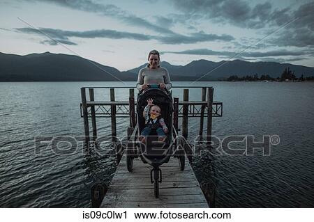 Mother with baby in pram on bridge by seaside, Te Anau, Southland, New Zealand View Large Photo Image Stock Image - Mother with baby in pram on bridge by seaside, Te Anau, Southland, New Zealand. Fotosearch