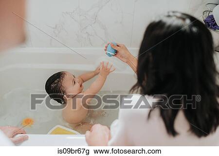 Mother with daughter at bath time View Large Photo Image Stock Image - Mother with daughter at bath time. Fotosearch