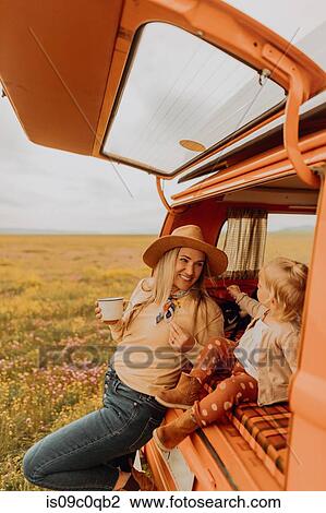 Stock Image - Mother with daughter on road trip in countryside. Fotosearch