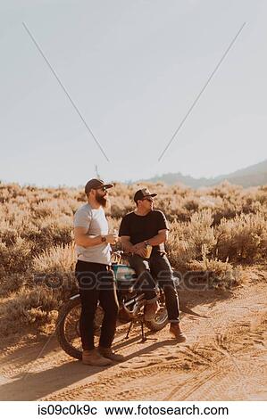 Motorbiker friends relaxing by motorbike, Kennedy Meadows, California, US View Large Photo Image Stock Image - Motorbiker friends relaxing by motorbike, Kennedy Meadows, California, US. Fotosearch
