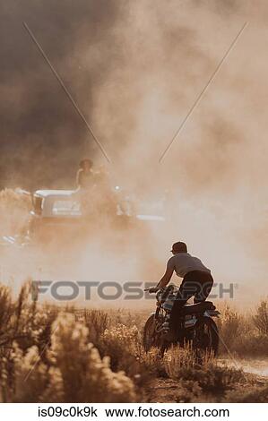 Motorbiker raising dust, Kennedy Meadows, California, US View Large Photo Image Stock Image - Motorbiker raising dust, Kennedy Meadows, California, US. Fotosearch