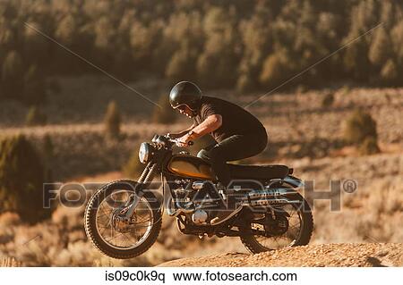 Motorbiker riding through landscape of Kennedy Meadows, California, US View Large Photo Image Stock Photography - Motorbiker riding through landscape of Kennedy Meadows, California, US. Fotosearch