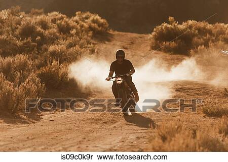 Motorbiker riding through landscape of Kennedy Meadows, California, US View Large Photo Image Stock Photography - Motorbiker riding through landscape of Kennedy Meadows, California, US. Fotosearch