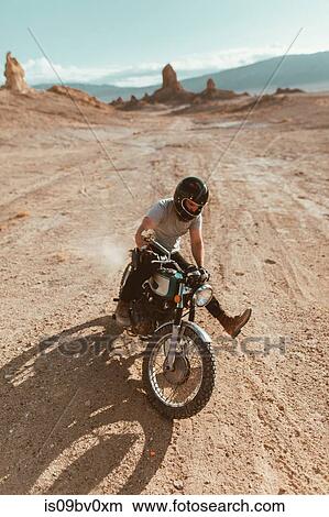 Picture - Motorcyclist enjoying stunts, Trona Pinnacles, California, US. Fotosearch