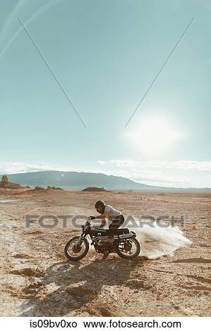 Motorcyclist enjoying stunts, Trona Pinnacles, California, US View Large Photo Image Picture - Motorcyclist enjoying stunts, Trona Pinnacles, California, US. Fotosearch