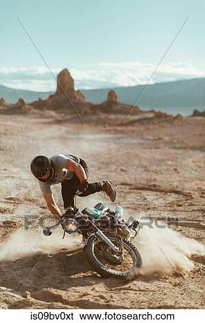 Stock Photograph - Motorcyclist enjoying stunts, Trona Pinnacles, California, US. Fotosearch
