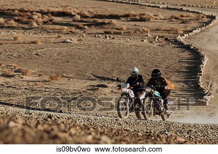 Motorcyclist friends riding in desert, Trona Pinnacles, California, US View Large Photo Image Picture - Motorcyclist friends riding in desert, Trona Pinnacles, California, US. Fotosearch