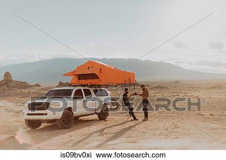 Motorcyclist friends taking break beside off road vehicle, Trona Pinnacles, California, US View Large Photo Image Stock Image - Motorcyclist friends taking break beside off road vehicle, Trona Pinnacles, California, US. Fotosearch