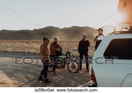 Motorcyclist friends taking break beside off road vehicle, Trona Pinnacles, California, US View Large Photo Image Stock Photograph - Motorcyclist friends taking break beside off road vehicle, Trona Pinnacles, California, US. Fotosearch