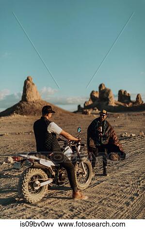 Motorcyclist friends talking on dirt track, Trona Pinnacles, California, US View Large Photo Image Stock Photo - Motorcyclist friends talking on dirt track, Trona Pinnacles, California, US. Fotosearch