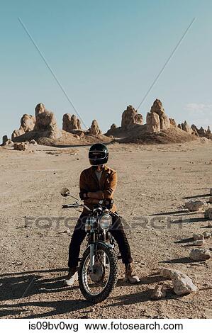 Motorcyclist on stationary bike, Trona Pinnacles, California, US View Large Photo Image Stock Image - Motorcyclist on stationary bike, Trona Pinnacles, California, US. Fotosearch