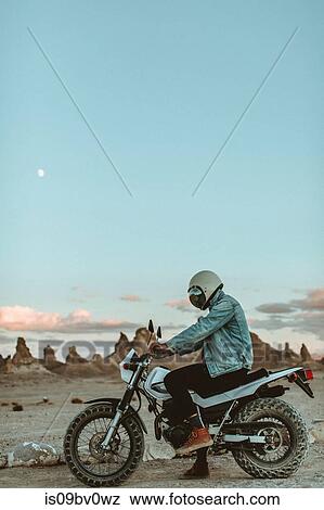 Motorcyclist on stationary bike, Trona Pinnacles, California, US View Large Photo Image Stock Photo - Motorcyclist on stationary bike, Trona Pinnacles, California, US. Fotosearch