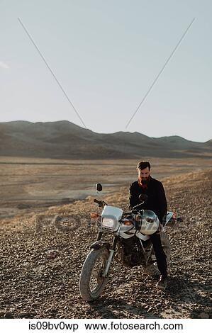Motorcyclist on stationary bike, Trona Pinnacles, California, US View Large Photo Image Stock Photography - Motorcyclist on stationary bike, Trona Pinnacles, California, US. Fotosearch