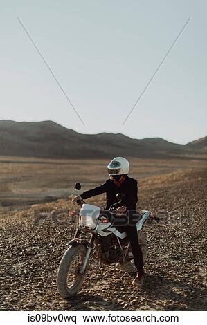 Motorcyclist on stationary bike, Trona Pinnacles, California, US View Large Photo Image Stock Photography - Motorcyclist on stationary bike, Trona Pinnacles, California, US. Fotosearch