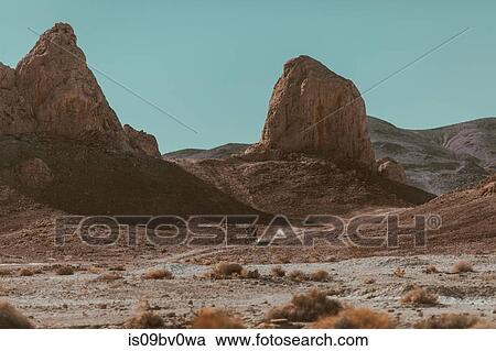 Stock Image - Motorcyclist riding in desert, Trona Pinnacles, California, US. Fotosearch