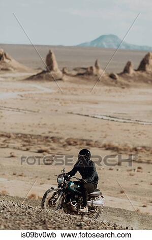 Motorcyclist riding in desert, Trona Pinnacles, California, US View Large Photo Image Stock Image - Motorcyclist riding in desert, Trona Pinnacles, California, US. Fotosearch