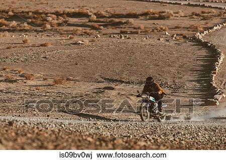 Motorcyclist riding in desert, Trona Pinnacles, California, US View Large Photo Image Stock Image - Motorcyclist riding in desert, Trona Pinnacles, California, US. Fotosearch
