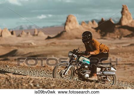Motorcyclist riding in desert, Trona Pinnacles, California, US View Large Photo Image Stock Image - Motorcyclist riding in desert, Trona Pinnacles, California, US. Fotosearch
