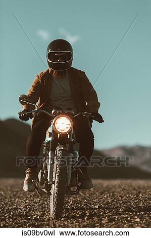 Motorcyclist riding in desert, Trona Pinnacles, California, US View Large Photo Image Stock Image - Motorcyclist riding in desert, Trona Pinnacles, California, US. Fotosearch